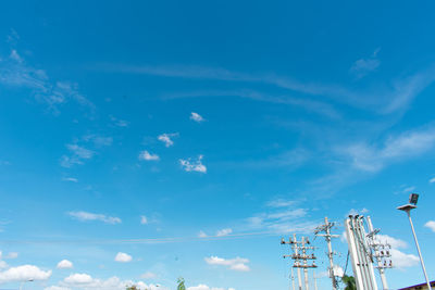 Low angle view of communications tower against blue sky