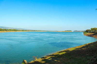 Scenic view of sea against clear blue sky