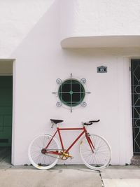 Bicycle parked by window of house