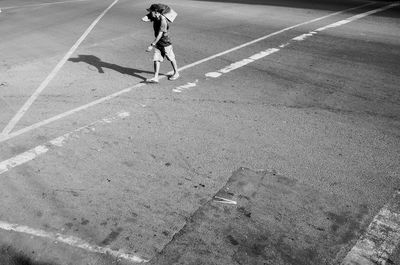 High angle view of man walking on road