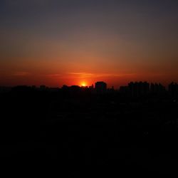 Silhouette of city during sunset