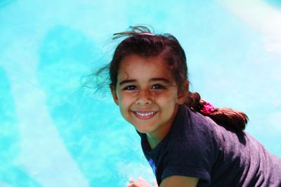 Portrait of smiling girl against swimming pool