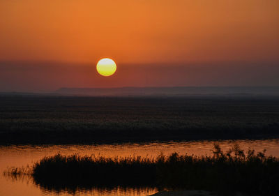 Scenic view of silhouette landscape against romantic sky at sunset