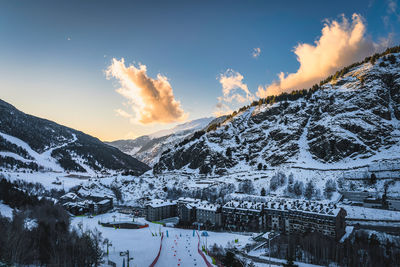 Bars, restaurants, hotels and residential building of el tarter and soldeu town at sunset, andorra