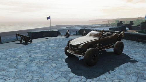 Vintage car on street by sea against sky