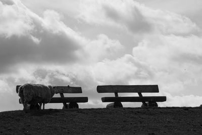 Benches on landscape against the sky