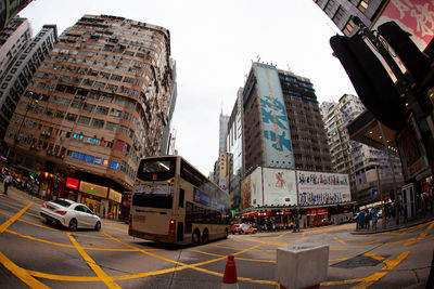 Panoramic view of city street and buildings against sky