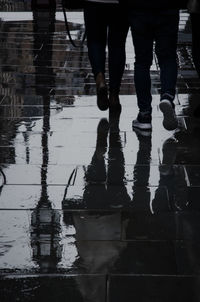 Low section of woman standing on tiled floor