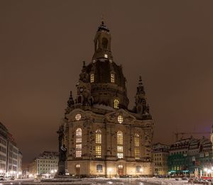 Low angle view of illuminated building against sky at night