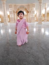 Portrait of cute girl standing on floor
