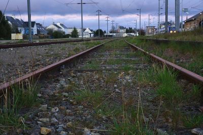 Railroad track against cloudy sky