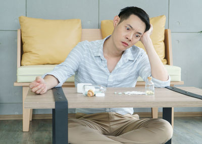 Young man sitting on table