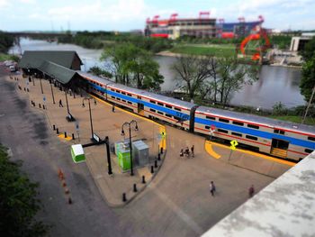 High angle view of train by river in city