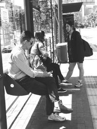 Young couple sitting in city