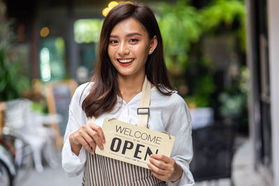 Portrait of young woman using mobile phone