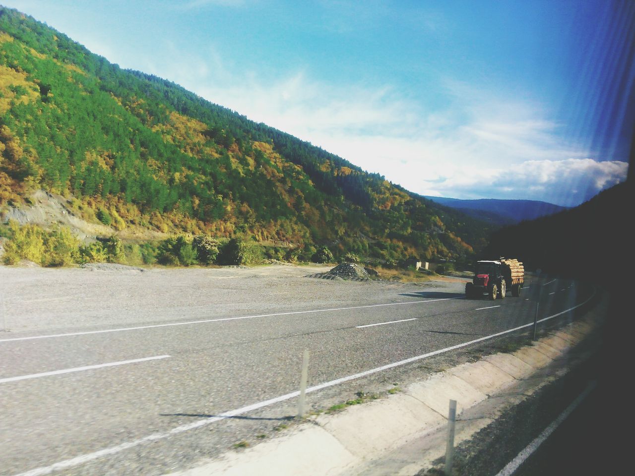 mountain, sky, mountain range, transportation, road, landscape, scenics, tranquil scene, nature, tranquility, cloud - sky, the way forward, beauty in nature, cloud, day, country road, travel, tree, non-urban scene, outdoors