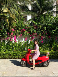 Full length of woman with pink flowers