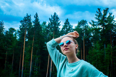 Portrait of boy wearing sunglasses against trees