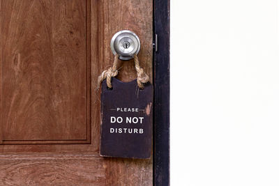 Close-up of text on wooden door