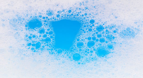 Close-up of bubbles against blue background