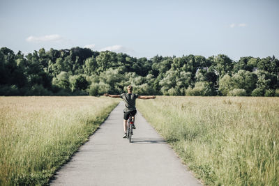 Young man riding a bike, freehand