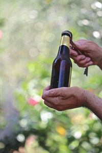 Close-up of hand holding glass bottle