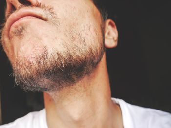 Close-up of man with short beard looking away 