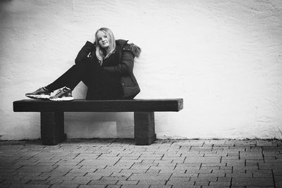 Portrait of young woman sitting outdoors