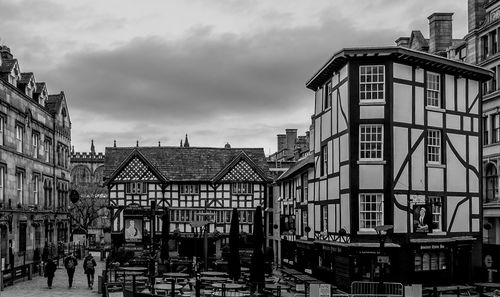 Buildings against cloudy sky
