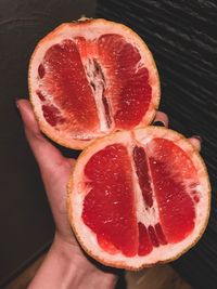 Close-up of hand holding strawberry