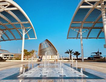 Fountain in front of business buildings at ayia napa mariana under the blue sky, low angle