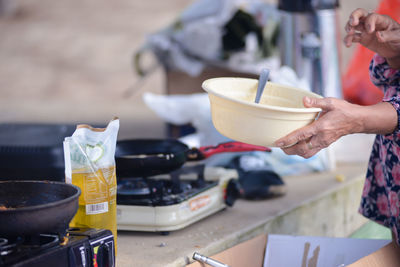 Midsection of man preparing food in kitchen