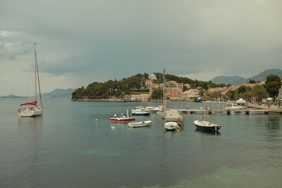 Boats in sea against sky