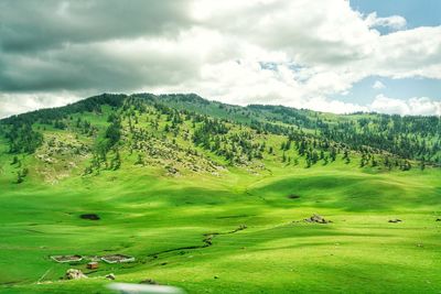 Scenic view of golf course against sky