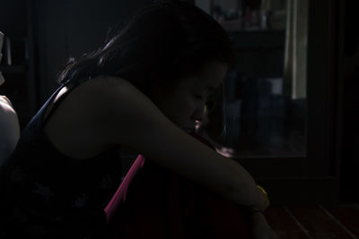 A asian being silhouette in her bedroom and sad woman sitting alone