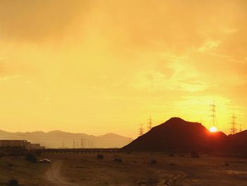 Scenic view of silhouette mountains against sky during sunset