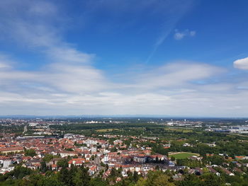 High angle view of town by sea against sky