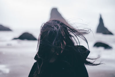 Woman tossing hair against the sea