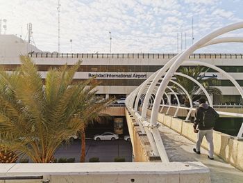 View of swimming pool by building against sky