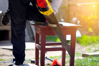 Low section of man working at workshop