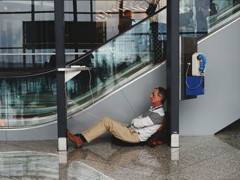 Man sitting by glass window