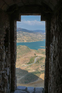 Scenic view of mountains seen through window