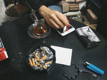 High angle view of man smoking cigarette on table
