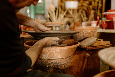 Midsection of man preparing food in kitchen