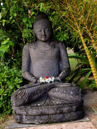 Statue of buddha on stone wall