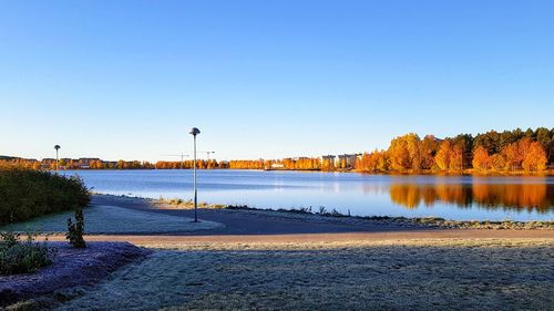 Scenic view of lake against clear blue sky