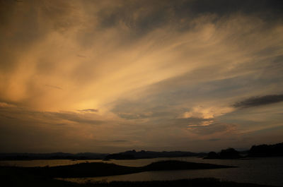 Scenic view of dramatic sky over silhouette landscape