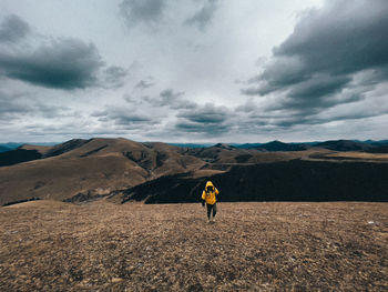 Woman on mountain against sky