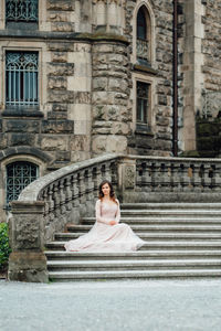 Woman sitting on staircase