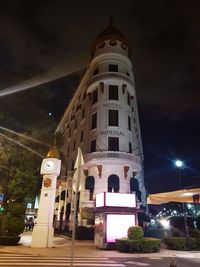 Low angle view of illuminated building against sky at night